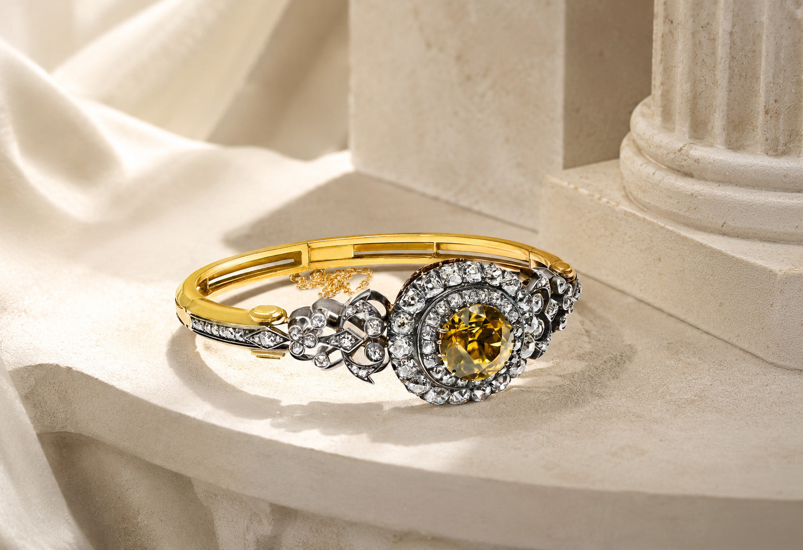 Victorian gold and diamond bangle bracelet on an ivory editorial background for DSF Antique Jewelry Reuters press coverage.