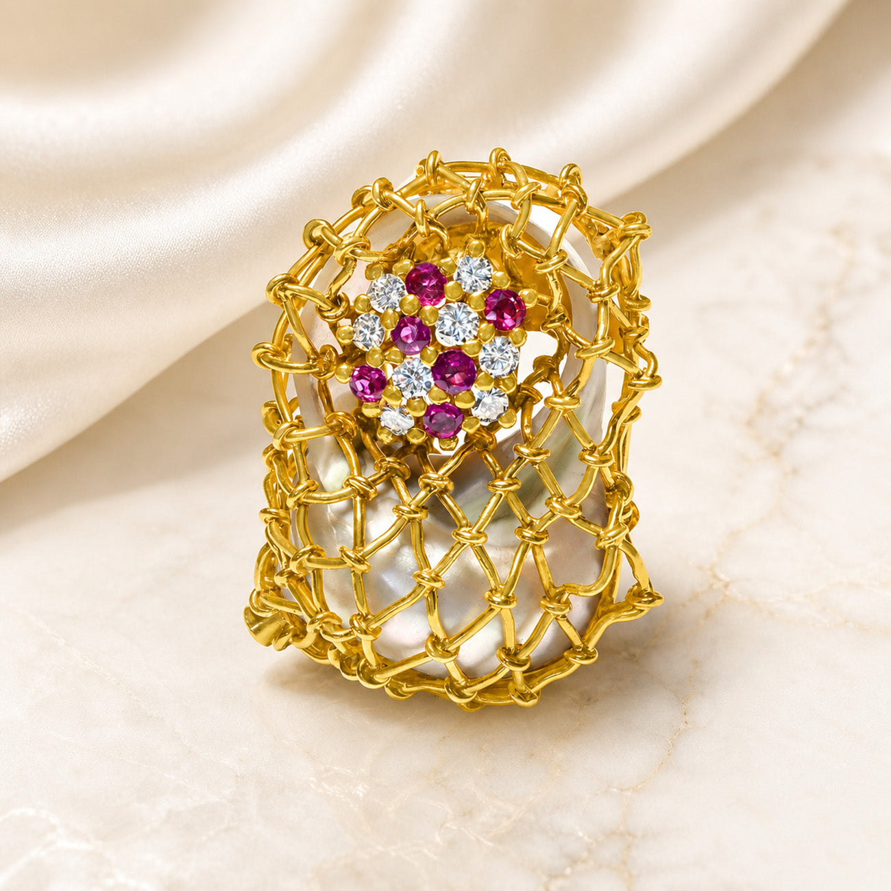gemstone brooch in gold on a marble silk background 