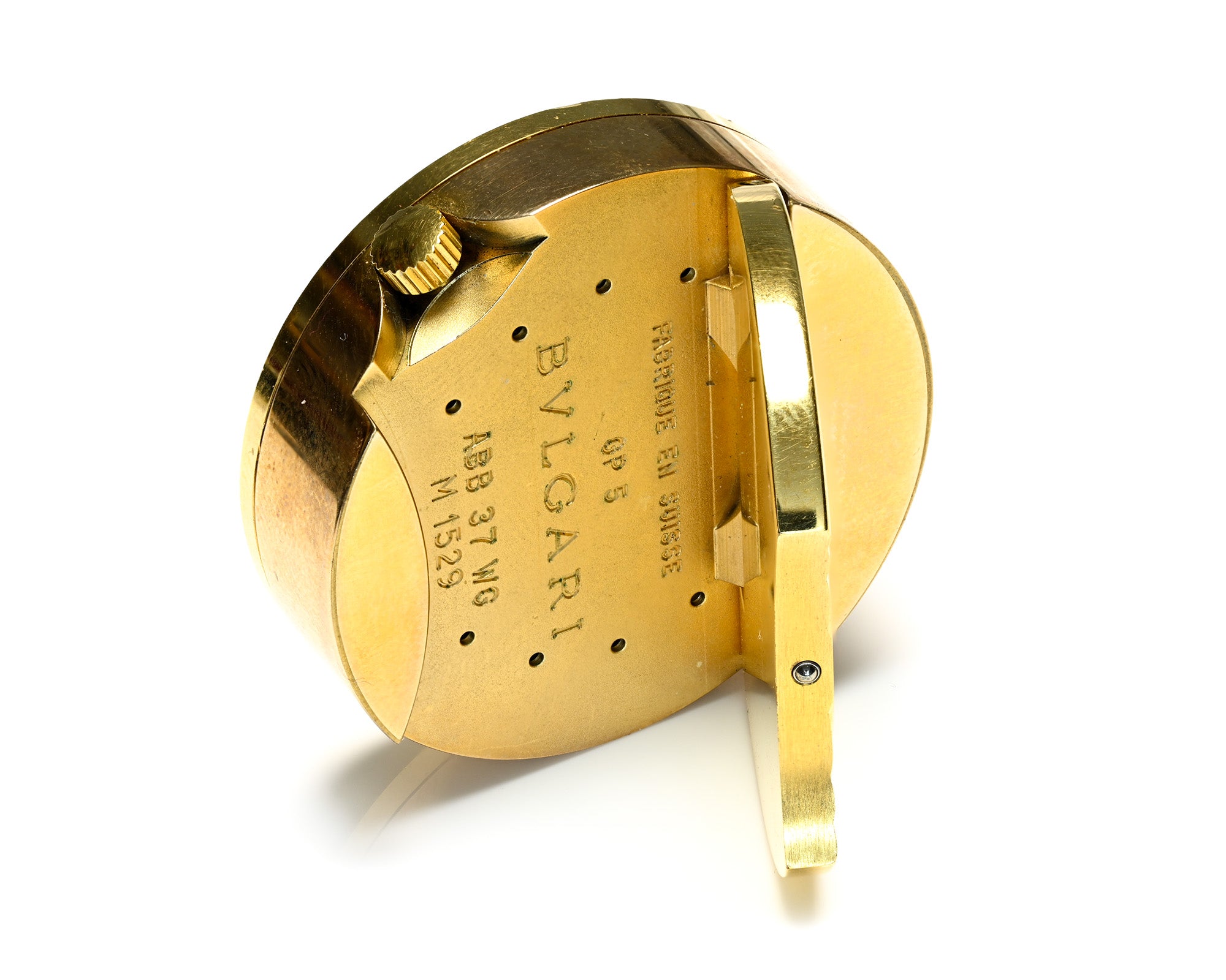 A vintage gold-tone Bulgari watch case, shown open to reveal the interior engraving and hinge mechanism, set against a plain white background.