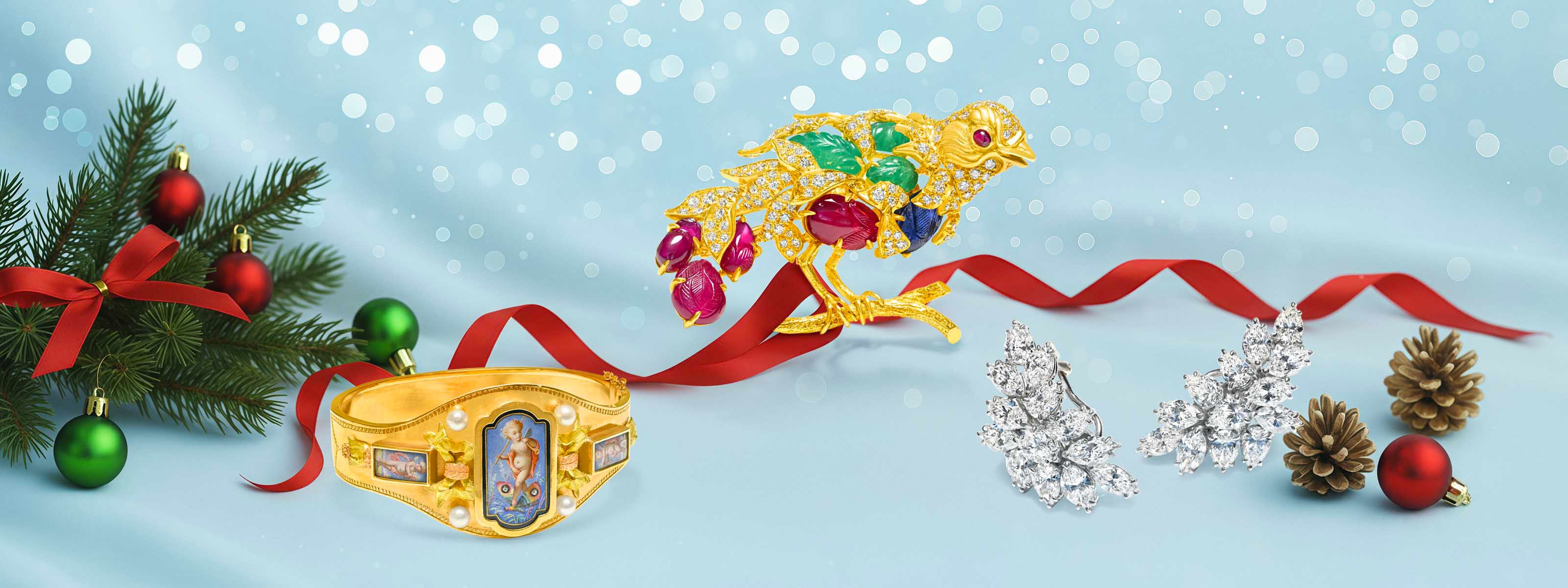 Luxury diamond earrings, gold bracelet, and gemstone brooch display featuring an antique gold bracelet, a jeweled gold bird brooch, and diamond cluster earrings set amid festive pine branches and ornaments — DSF Antique Jewelry.